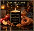 The Bear Essence Apple Cider Donuts candle with crisp apples, cinnamon sticks, and sugar-dusted donuts on dark marble